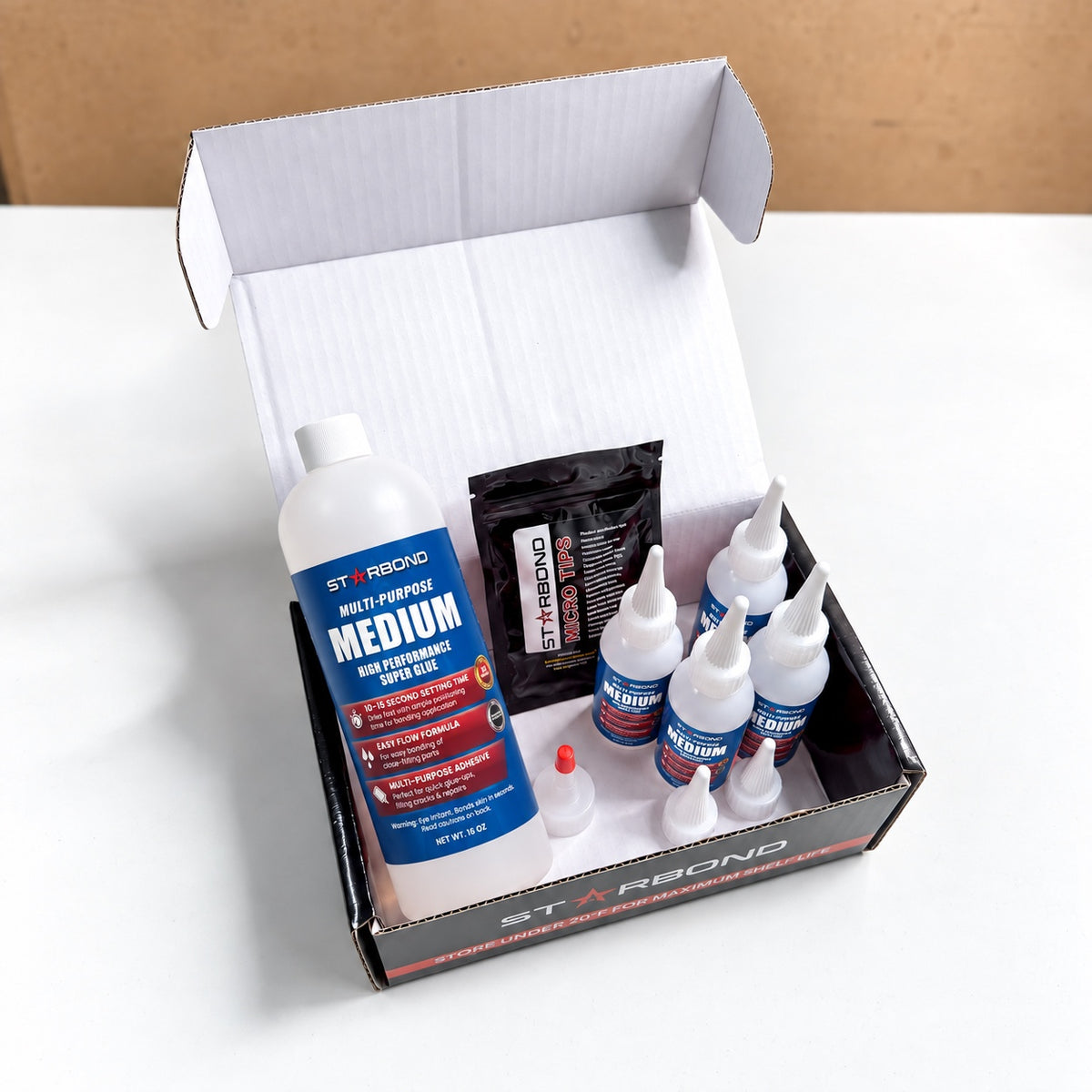 Starbond medium 16 oz kit in an open box with four small dispensing bottles and applicator accessories.