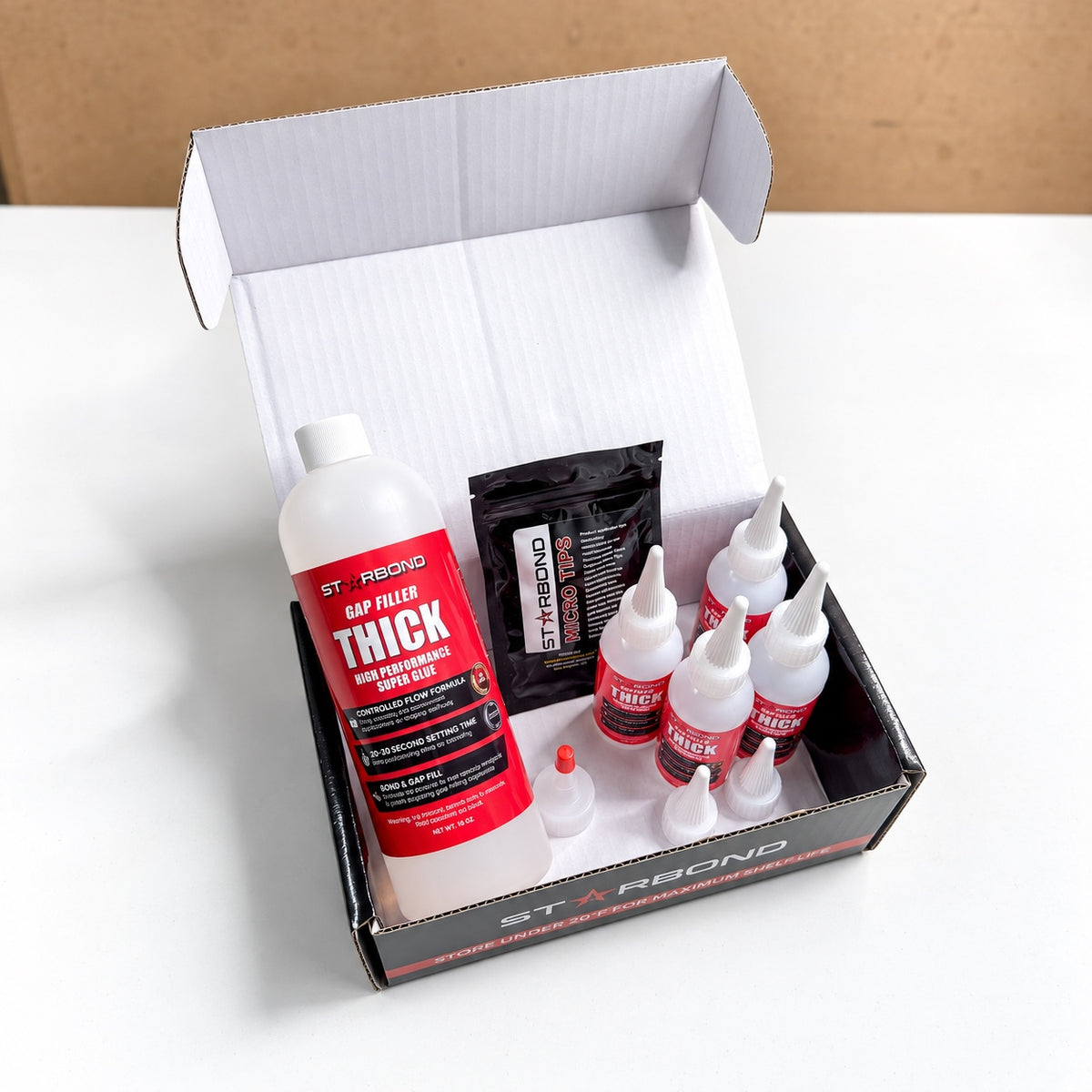 Starbond thick 16 oz kit in an open box with four small dispensing bottles and applicator accessories.